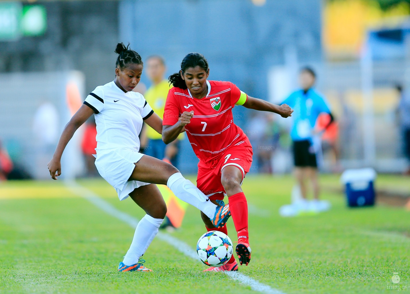 Fadhwa Zahir of Maldives beats Mayotte defender in Women's football event in La Reunion', Wednesday, July. 31, 2015.  (Images.mv Photo/ Hussain Sinan).